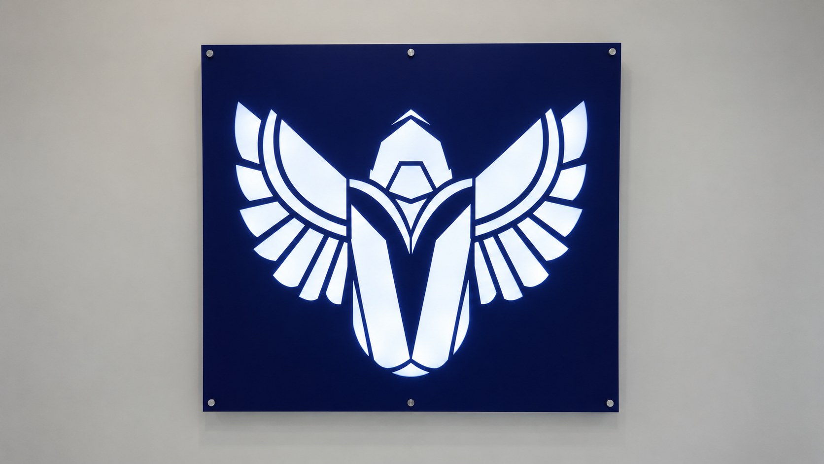 Raad Team gaming house — Illuminated navy winged-emblem wall panel